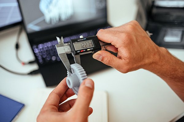 mechanical engineering measuring prototype with calipers
