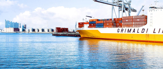 Large Boat at Port with Sea Freight Shipping Containers