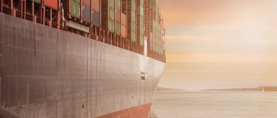 Freight ocean shipment with sunset behind