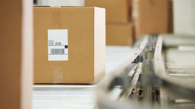 Shipping boxes on conveyor belt in warehouse